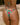 Woman wearing brazilian cut watermelon print bikini on beach