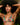 Woman wearing a floral bikini top with a tropical background