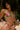 Woman wearing a colorful bikini with a floral pattern on a beach.