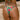 Woman wearing brazilian cut watermelon print bikini on beach