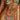 Person wearing a colourful bikini with floral and watermelon design.
