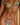 Person wearing a colourful bikini with floral and watermelon design.