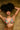 Woman wearing a colorful bikini against a wooden panel background