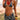 Woman in a patterned bikini and cover-up standing on a beach.