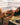 Woman in a bikini lying on a wooden bench by the beach