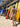 Person in a bikini standing next to surfboards on a beach