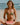 Woman in a bikini holding a watermelon slice on a beach