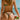 Person in a colorful bikini holding a watermelon on a beach