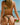 Person in a colorful bikini holding a watermelon on a beach