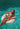 Woman in a bikini lying on an inflatable ring in clear blue water